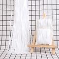 White fringe foil curtain for party backdrop decoration displayed on a plaid background - Small / Macaron White
