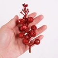 Detailed view of handmade red glitter berry stems for DIY Christmas wreath decoration - Red