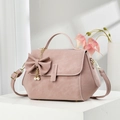 Elegant dusty pink crossbody handbag featuring a decorative bow and double pearl charms - Pink