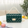 Dark green quilted jelly bag with pearl handle and golden chain strap in a soft crossbody style - Dark Green