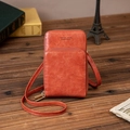 Sac bandoulière en cuir vintage sur un bureau avec un décor rétro classique - Orange