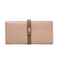 Detail of leaf embroidery and golden metal leaf ornament on a soft pink leather wallet - Pink