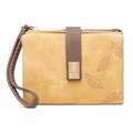 Macro view of ginger yellow PU leather wallet with leaf print and metal logo buckle - Yellow