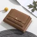 Detail of brown PU leather trifold wallet featuring vertical stripes and a gold metal buckle - Brown