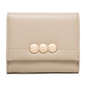 Detail of light beige leather wallet featuring three golden metal leaf buckle closures - Apricot