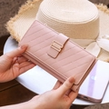 Detailed view of the dusty pink quilted leather long wallet with elegant gold buckle - Pink