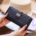 Detail of black faux leather long wallet with quilted stripes and gold metal clasp - Black