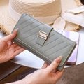 Sage green long quilted leather wallet with secure buckle closure and multiple card slots - Green