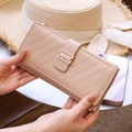 Detail of apricot striped quilted long wallet with golden buckle and multi-layer slots - Apricot