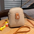 Chic beige and caramel crossbody mobile phone bag with cute tiger mascot on a wooden table - Khaki