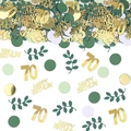 Close-up of 70th birthday party confetti with gold letters and green leaves - 70 Years Old Birthday Style