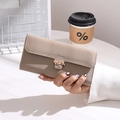 Close-up of khaki long wallet featuring a golden leaf buckle and matte PU leather texture - Camel