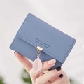 Short PU leather wallet in Morandi blue featuring a pink leaf charm and gold clasp - Dark Blue