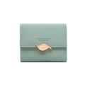 Close-up of light green short wallet with gold leaf buckle and white stitching detail - Matcha Green
