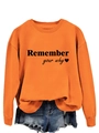 Close-up of orange sweatshirt with Remember Your Why print and ribbed sleeve cuffs - S / Orange Sweatshirt (Black Font)