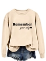 Detail view of Remember Your Why black lettering on a light beige crewneck sweatshirt - S / Sand Sweatshirt (Black Font)