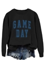 Detail of GAME DAY printed black sweatshirt paired with distressed denim shorts - S / Black
