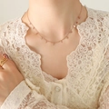 Rose gold choker necklace with delicate leaf charms worn by a model in lace attire - Rose Gold Leaf Style