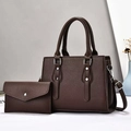 Close-up of deep brown lychee texture leather tote bag set with silver rivets and handles - Coffee