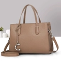 Detail of a brown leather handbag with fine grain texture and silver C-shaped metal charm - Dark Khaki