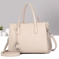 Detail view of beige leather tote bag featuring a silver C pendant and detachable strap - Light Khaki