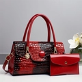 Detail of red crocodile texture handbag set with polished gold hardware and matching pouch - 30cmx12cmx18cm / Burgundy