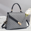 Chic black and white color-block handbag with geometric pattern and gold clasp hardware - Black