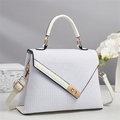 Close-up of white embossed square pattern leather bag with golden metal twist lock - Off-white