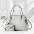 Detail of grey pebbled leather shell bag with matching mini coin purse and silver hardware - Gray