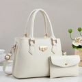 Close-up of a white lychee grain leather tote bag set with elegant gold buckle hardware - Off-white