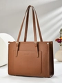 Detail of brown litchi pattern tote bag with golden hardware and fashion logo - Earthy Yellow