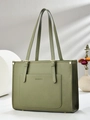 Close-up of dark green lychee grain leather tote bag featuring gold hardware and embossed logo - Green