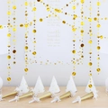 Detail of gold glitter star garlands, party hats, and blowouts for festive birthday decor - Gold