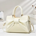 Detail of beige pleated bow handbag with woven texture and gold circular handles - Off White