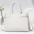 Close-up of white lychee grain leather tote bag with silver hardware and shoulder strap - 33x13x23cm / Off White