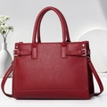 Dettaglio della borsa tote rosso scuro con pelle testurizzata litchi e fibbie in metallo argento - 33x13x23cm / Rosso Mattone