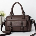 Brown lychee leather tote bag with wide strap and decorative buckles on a white background - Coffee