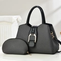 Black fabric tote bag with gold horsebit detail and matching small pouch on a pedestal - Black