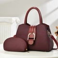 Detailed close-up of wine red hobo bag set with gold hardware on a display stand - Red
