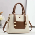 Close-up of litchi texture leather handbag with bicolor design and gold buckle detail - Off-white