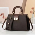 Retro dark brown handbag with top handle and adjustable shoulder strap in indoor setting - Coffee