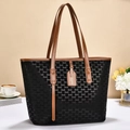 Detailed close-up of large tote bag with monogram pattern and brown leather straps - 32x13x27cm / Black