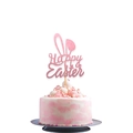 Close-up of pink glittery Happy Easter bunny ear cake topper on a cream cake - Pink