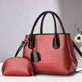 Detail of red croc-embossed patent leather tote and matching zipper coin purse set - Wine Red