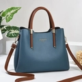 Blauwe dames handtas van lycheeleer met bruine handvatten en schouderriem - Blauw
