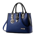Bolso de mano minimalista en azul marino y negro con un colgante de corazón dorado - Azul