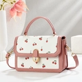 Pink and white cherry print crossbody bag with top handle and gold-tone hardware detail - Pink