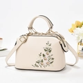 Elegant cream shoulder bag featuring floral embroidery and gold metal hardware accents - Off White
