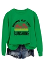 Close-up of Bring On The Sunshine graphic print on green crewneck sweatshirt fabric - S / Tops / Grass Green (Black Print)