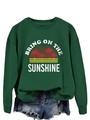 Close-up of the vintage palm tree print and Bring On The Sunshine text on green sweatshirt - Dark Green (White Print)